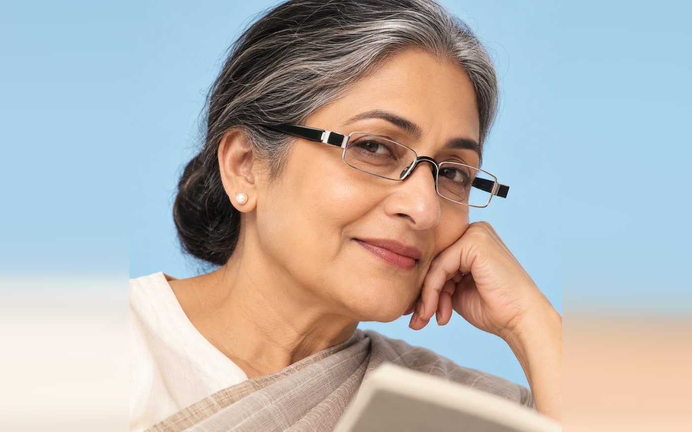 A woman wearing rimless reading glasses