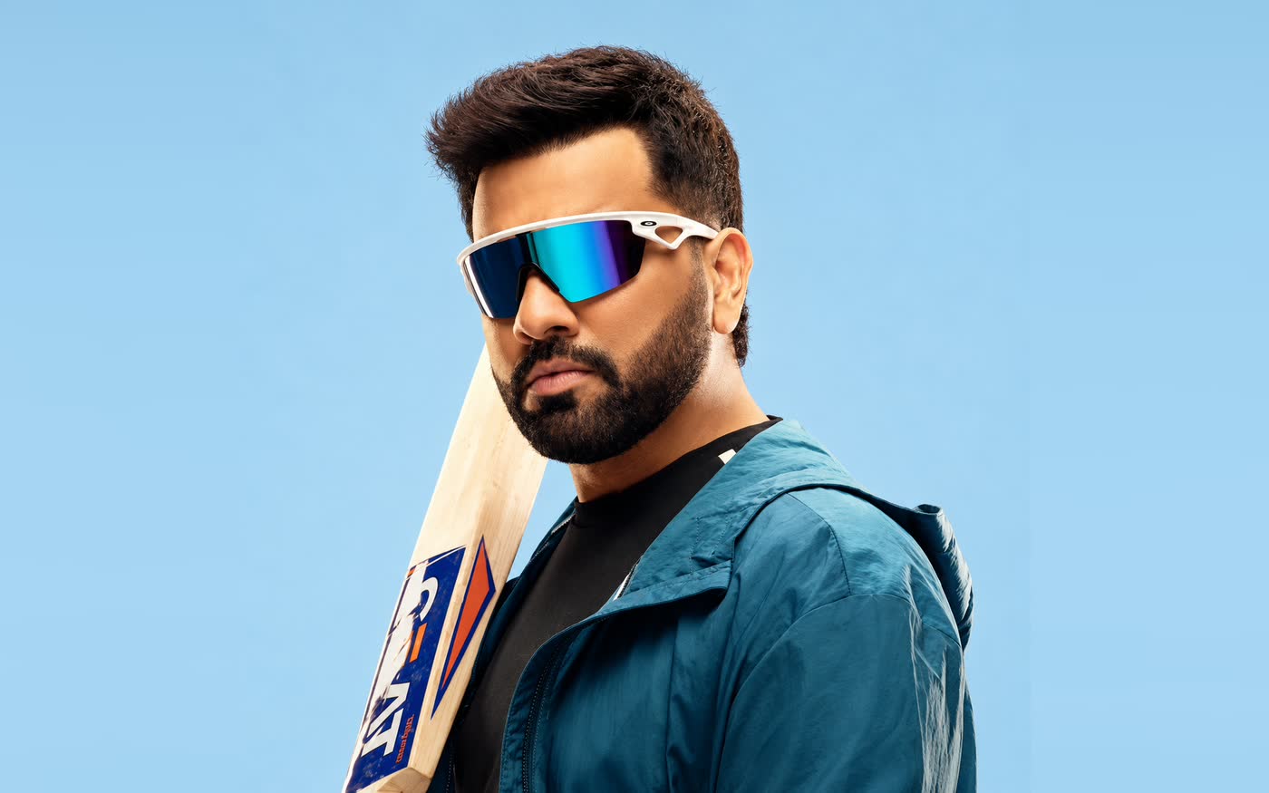 A cricketer wearing wraparound sports sunglasses