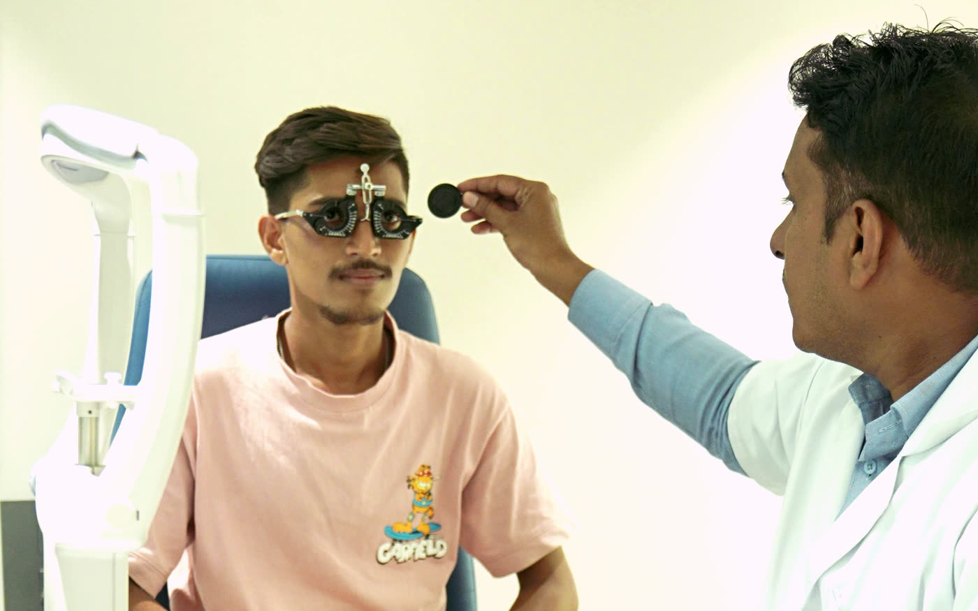 An optometrist fitting a trial frame during an eye test at Panorama Vision, Jalgaon